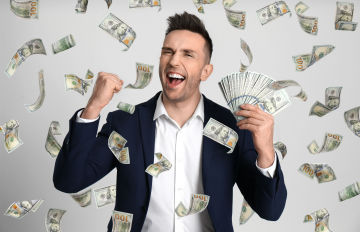a young man exhilarating and surrounded by floating money as he has just won a huge jackpot
