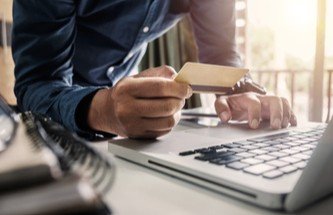 Player swiping a credit card on his laptop