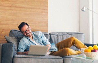 happy gamer playing on his laptop