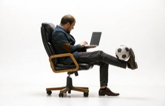 a player lounging on the sofa playing games on a laptop