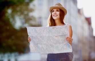 happy tourist looking at a map