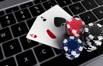 poker chips and two Aces on a laptop keyboard