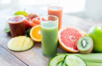 healthy vegetables, fruits and fruit drinks arranged on the table