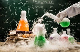 a science lab with a hand pouring chemicals from container to container