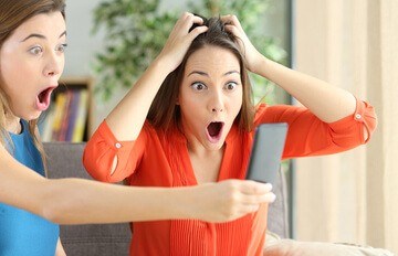 two women very excited looking at the promotions at Everygame Casino