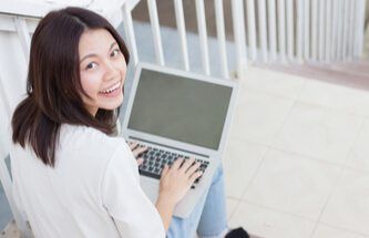 woman enjoying playing on his laptop