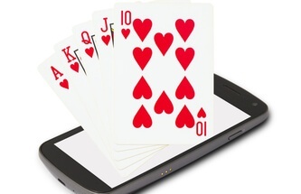 A - K - Q - J - 10 of hearts cards coming out of a mobile phone screen