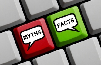 computer keyboard with a red key marked Myths and a green key marked Facts referring to busting slot myths