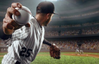 a baseball pitcher pitching a ball in a professional baseball stadium