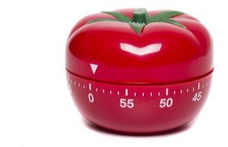 a red kitchen timer in the shape of a tomato