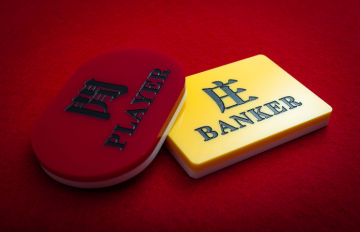 two baccarat betting tiles, one red one for the player bet and a yellow one for the banker bet
