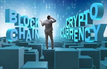 a man standing on blocks looking at the words Blockchain and Cryptocurrency and scratching his head trying to understand