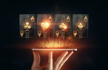 Hologram style image of 4 Ace cards floating above a phone being held in a man's hand
