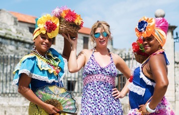 three women enjoying a Caribbean vacation. The image uses many colors to create a warm and inviting winter vacation mood