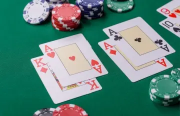 three blackjack hands on a green felt table with red, green, white, and blue chips around