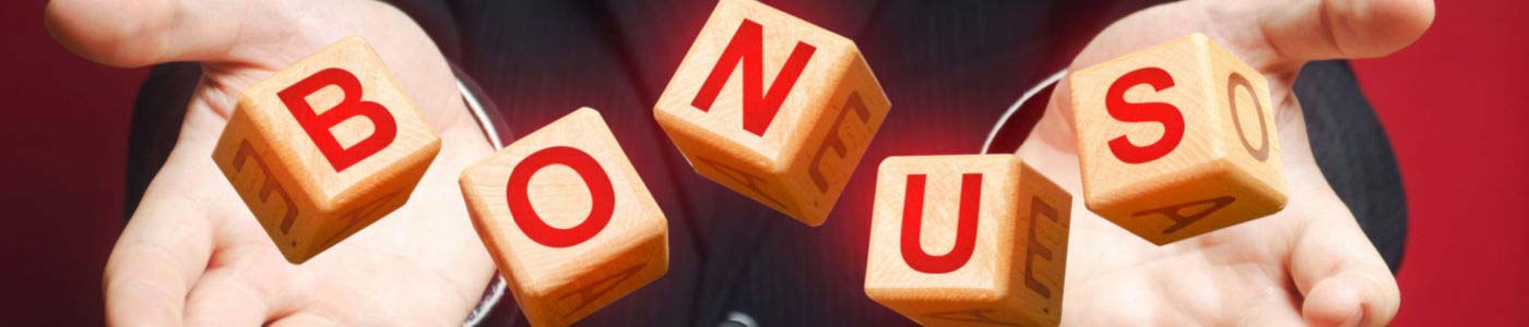 businessman with suit and tie tossing five cubes in the air with the word bonus spelled out in red letters.