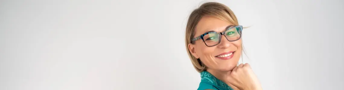 a very attractive middle-aged woman smiling effortlessly demonstarting a deep level of emotional maturity