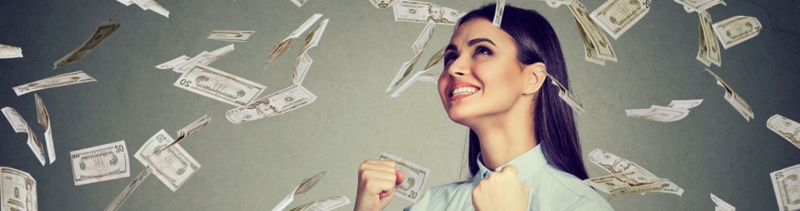 A young woman standing under a shower of money symbolizing the money online casino bonuses give gamers.