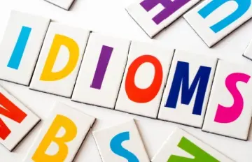 the word idioms spelled out in colorful letters with other colorful letters around