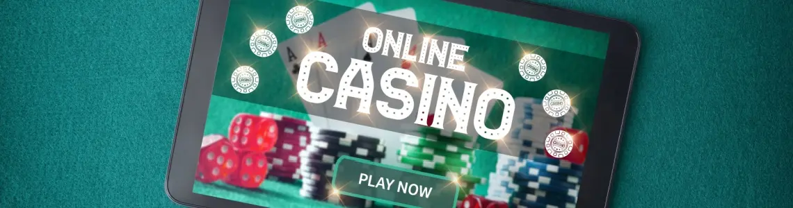 a large tablet with online casino on the screen surrounded by dice and casino chips