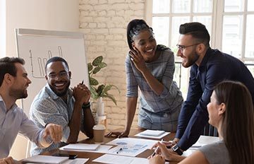 team of five young people, two women and three men, working on a new marketing plan