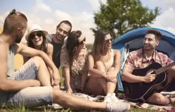 a group of young people, three men and three women, out together camping and having a great time