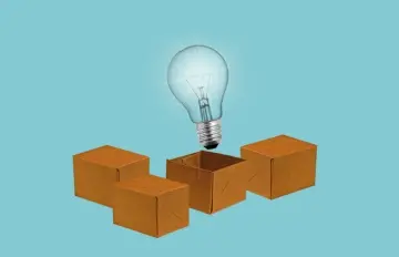a light bulb coming out of a box indicating thinking outside the box