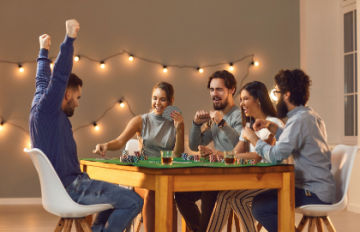 five young people, three men and two women, enjoying playing table games