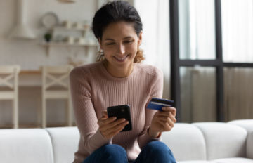happy young woman enjoying the convenience of shopping online