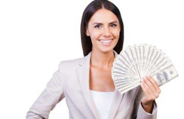 a young professional woman fanning money as a demonstration of how good money management results in making money