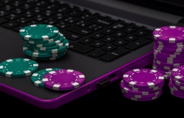 green and red casino chips on top of a keyboard indicating online casino gaming