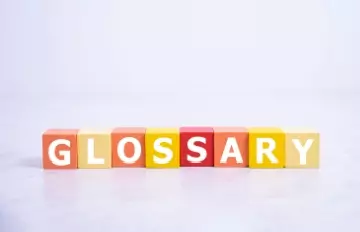 The word glossary made out of colorful blocks in shades of yellow and red