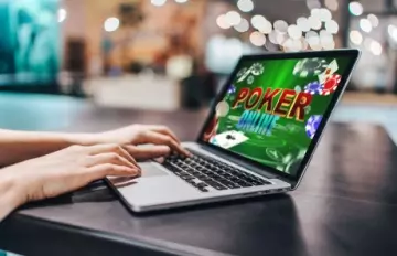 woman playing poker online on her laptop computer