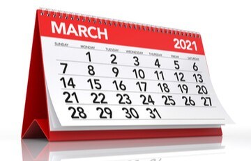 a desk-top calendar in red showing March 2021