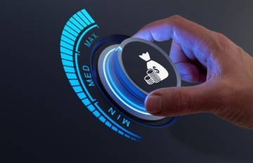 A concept image of a hand on a dial with an image of money on it turning the dial from ‘low’ to ‘max’ on a dark background 