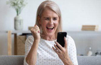 a woman winning playing slots on her phone