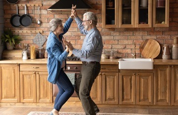 an older couple dancing to the music together