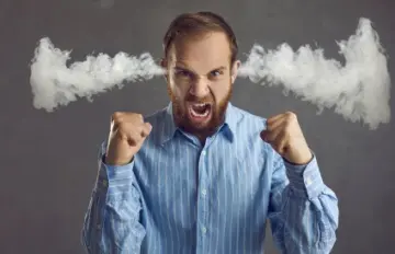 a bearded young man very angry with steam coming out of his ears