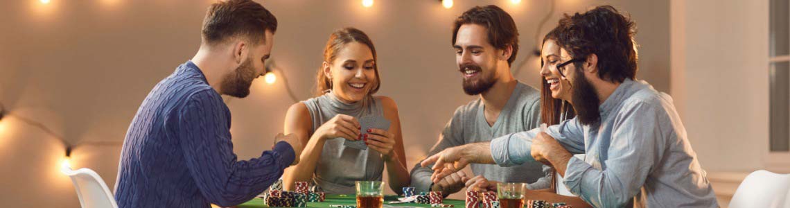 five twenty-something friends having a great time playing casino-themed table games at home