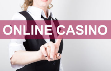 a young businesswoman wearing a tie and vest pointing to the word casino on the screen in front of her