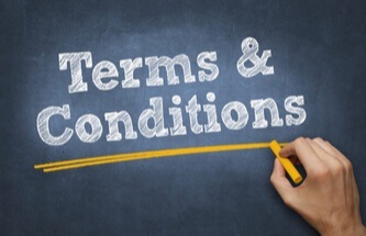 Terms and Conditions written on a chalk board with a man drawing a yellow line under it