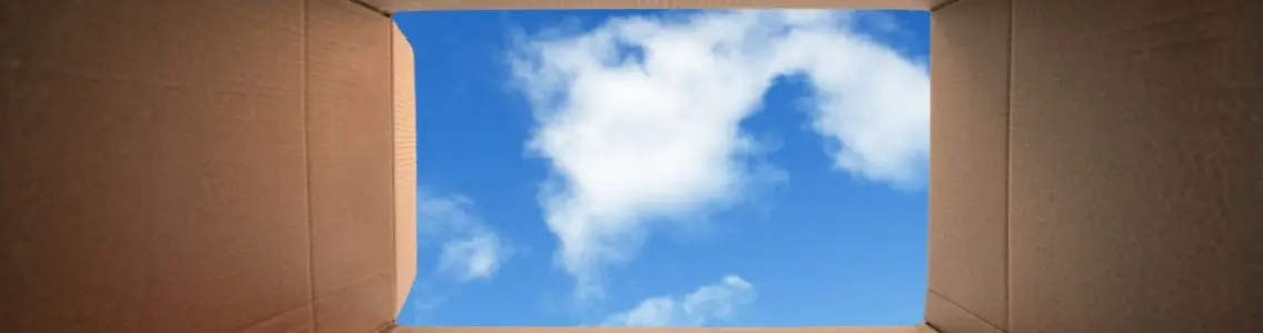 a view of a cloudy blue sky from inside a box symbolizing thinking out of the box
