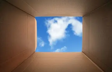a view of a cloudy blue sky from inside a box symbolizing thinking out of the box