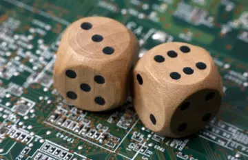 two wooden die on top of a computer mother board showing random numbers to exemplify the idea of the random number generator