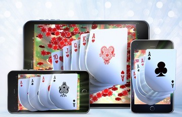 playing cards and different colored chips emanating from two smartphones and a tablet