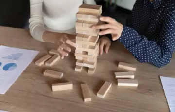 two women playing Jenga