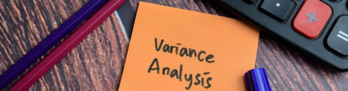 idea of variance shown by calculator on desk with two pencils and note pad with words variance analysis on it