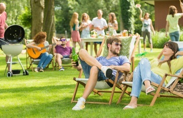 a group of happy young friends having a picnic at an a picnic area out in the countryside