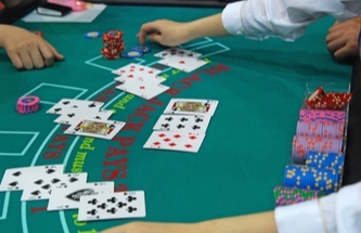 blackjack player in front of a blackjack table